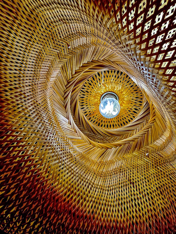 why-choose-us Captivating view of a woven wicker light fixture showcasing intricate patterns and design.