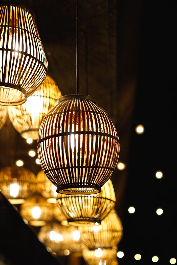 Elegant hanging lights with woven bamboo shades create a warm ambiance.
