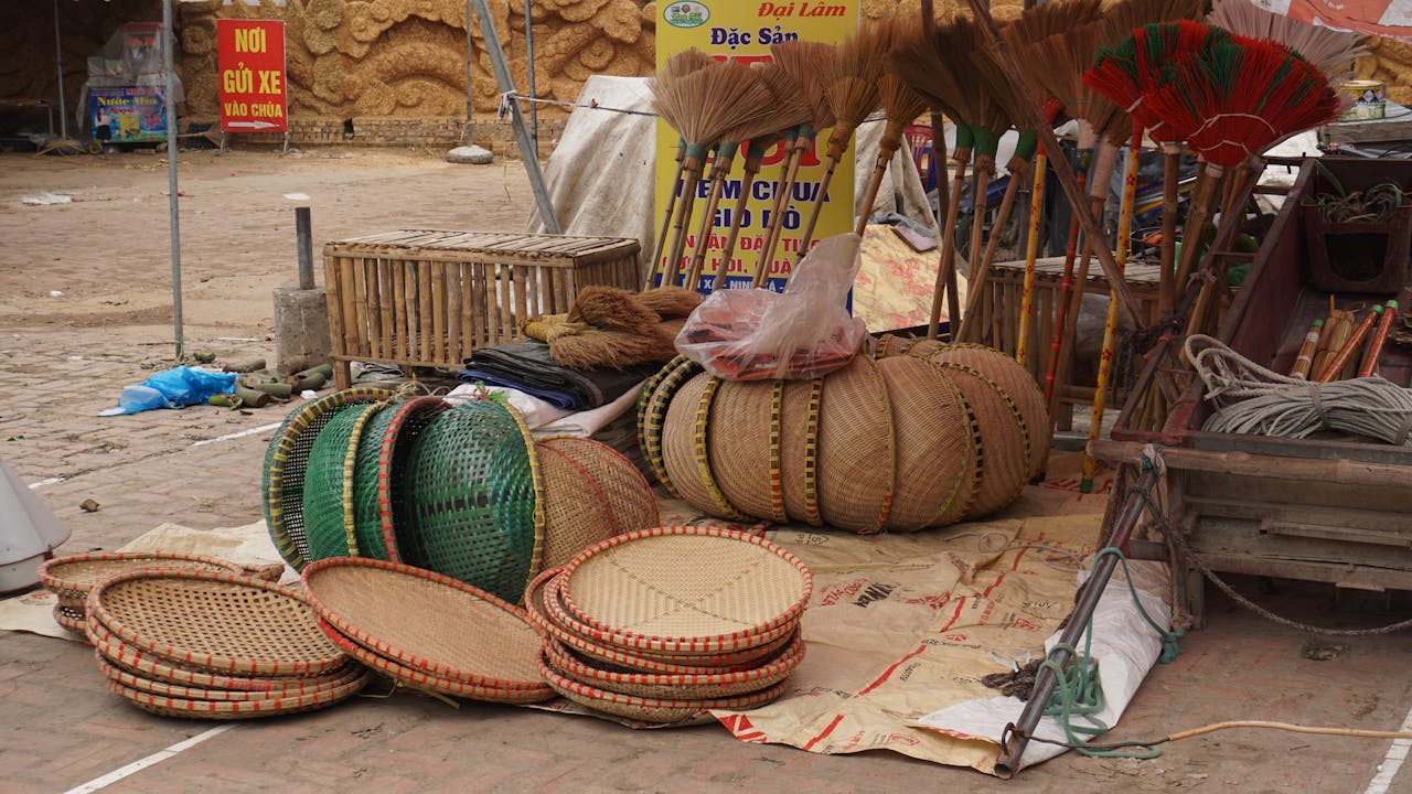 services-02 Rustic Vietnamese market scene with baskets, brooms, and local handicrafts on display.